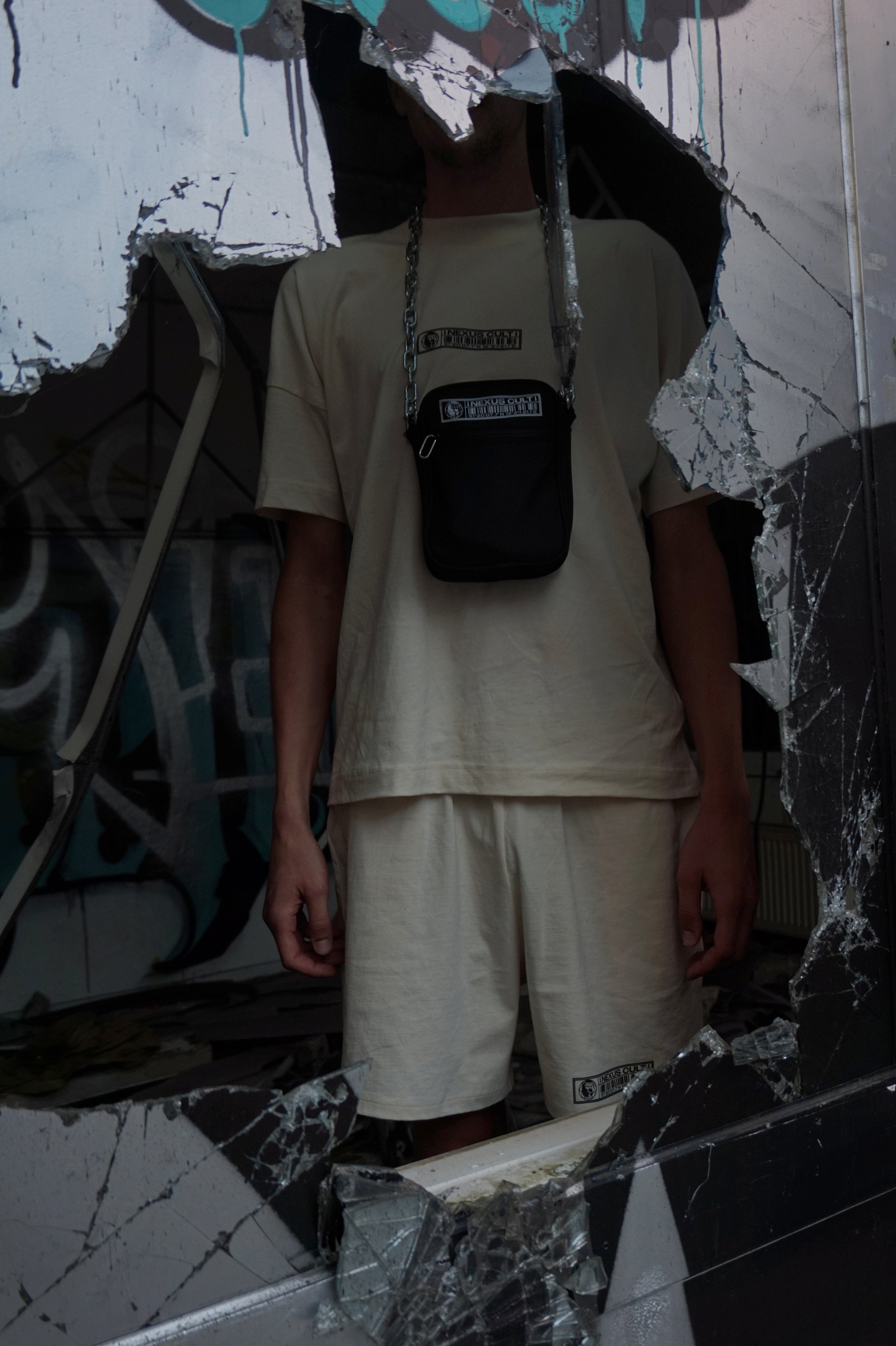 SCHWARZE TASCHE MIT KETTE UND AUFDRUCK.